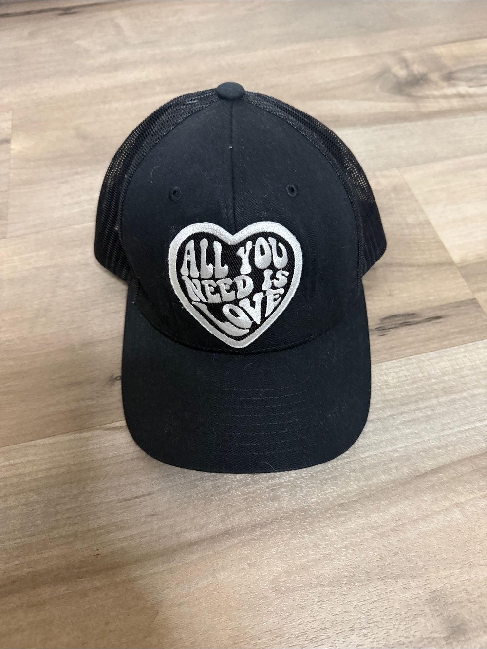 The Classic Black Trucker Hat with White Heart Patch